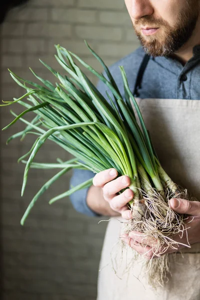 Young Man Rustic Apron Holding Bunch Green Onions Healthy Vegetarian — Stock Photo, Image