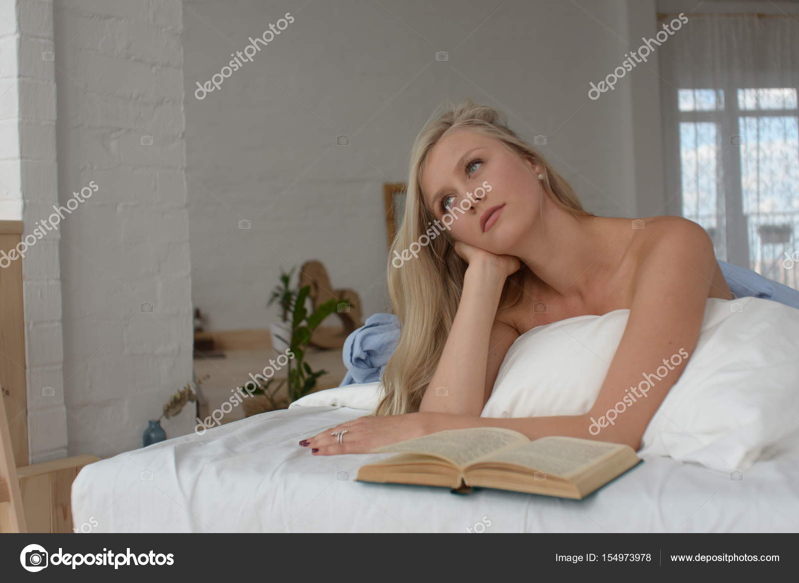 Beautiful Blonde Woman Lying On The Bed Comfortably Dreamig And