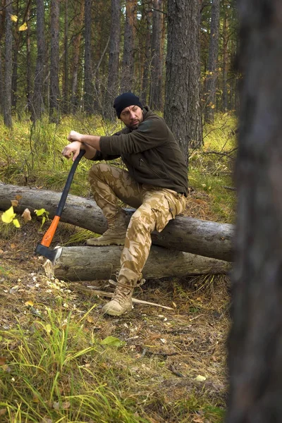 Lumberjack worker sitting in the forest .Resting after hard work. — Stock Photo, Image