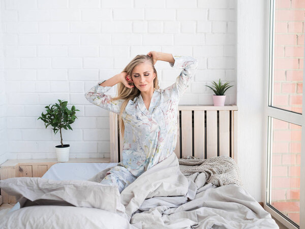 Happy Young Woman Waking Up On Bed In Morning