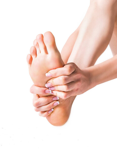Pain in the foot. Massage of female feet. Isolated on white background.