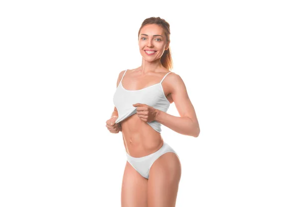 Mulher sorridente em lingerie branca mostrando sua cintura. Isolado em branco . — Fotografia de Stock