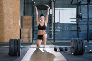 Bir kadının ön portriatını kapatmak spor yaparken ağırlık kaldırmaktır. Bacaklar için egzersiz. Sağlıklı yaşam tarzı kavramı.