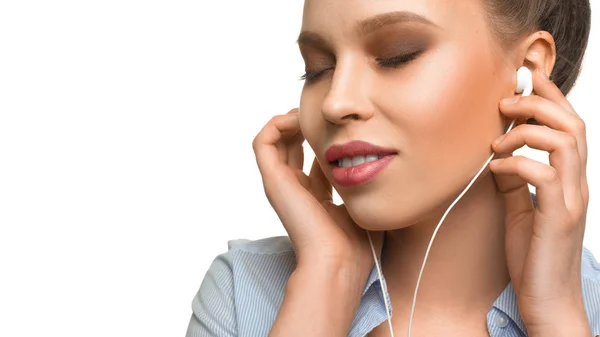 Portrait d'une jeune femme écoutant la musique via des écouteurs . — Photo