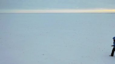 Man with red backpack walking by the tundra. Strength, overcoming and tough travel concept.