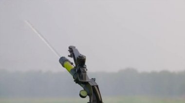 Process of working irrigation sprincler on an agricultural field. Close up video.