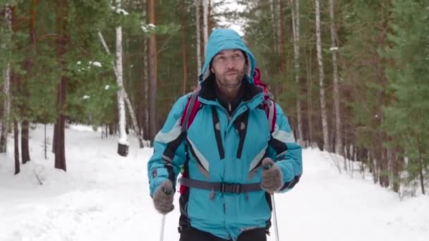 Human with backpack walk throw the winter forest. — Stock Video