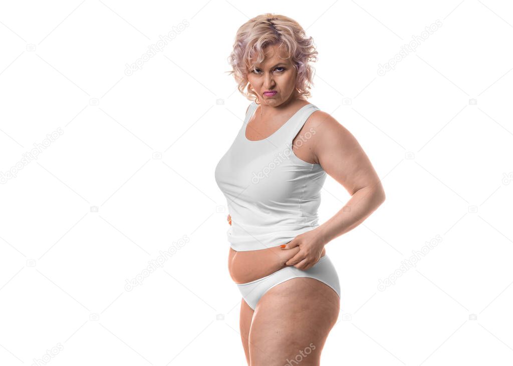 Portrait of a middle-aged woman unhappy with her figure. Cellulite and obesity.