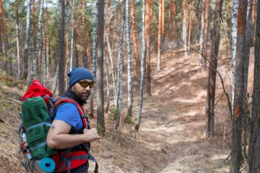 Ormanda sırt çantalı bir erkek turist. Portreyi kapat..