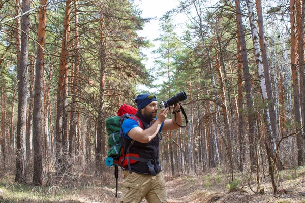 Ornithologue marche à travers les bois avec une caméra et faire des photos des oiseaux . — Photo