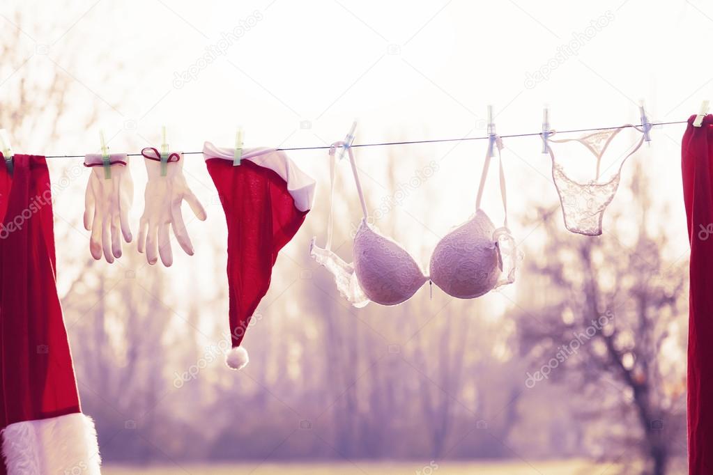santa claus suit hung out to dry mixed with lingerie
