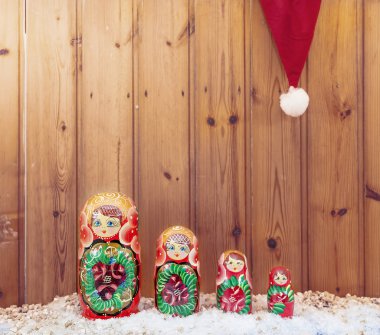 set of matryoshka covered by christmas hat warm look filtered