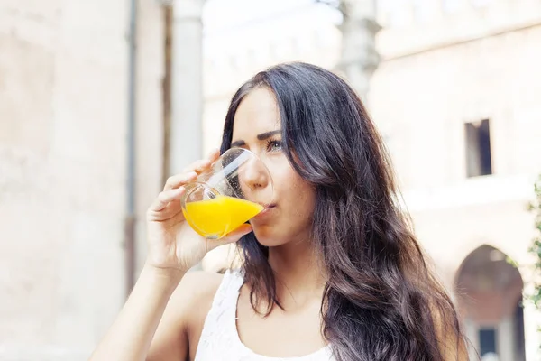 Portrait of attractive girl while drinking an orange juice — Stock Photo, Image