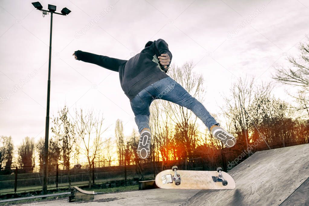 young skateboarder jumping on a ramp outdoor