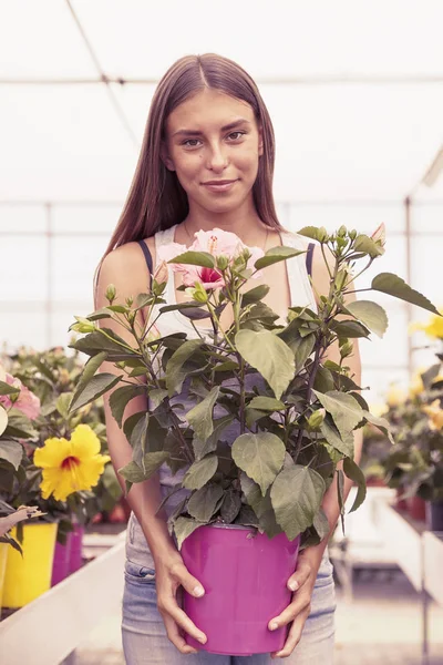 young flower seller takes care of her beautiful flowers