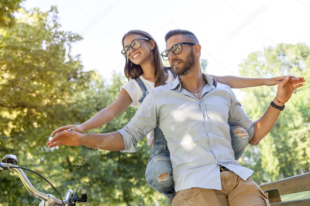 beautiful young couple having fun in the park