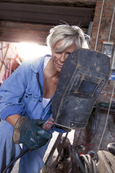 beautiful lady at work in his old workshop