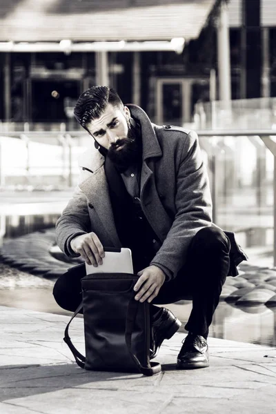 Young hipster businessman consults his laptop — Stock Photo, Image