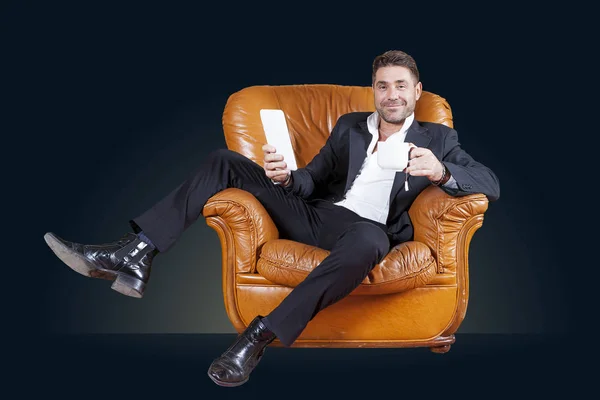 Young businessman sitting in his leather chair — Stock Photo, Image