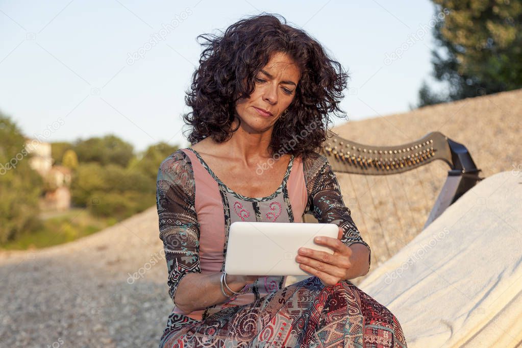 portrait of beautiful harpist woman typing messages