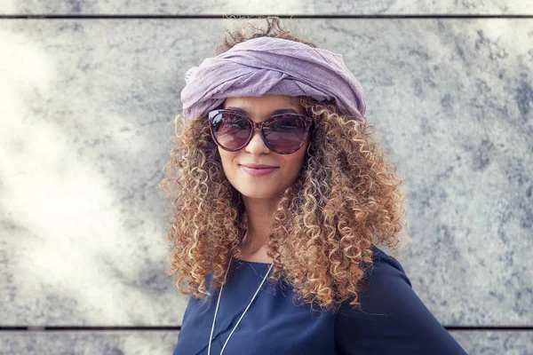 Portrait of young woman with blond curls — Stock Photo, Image