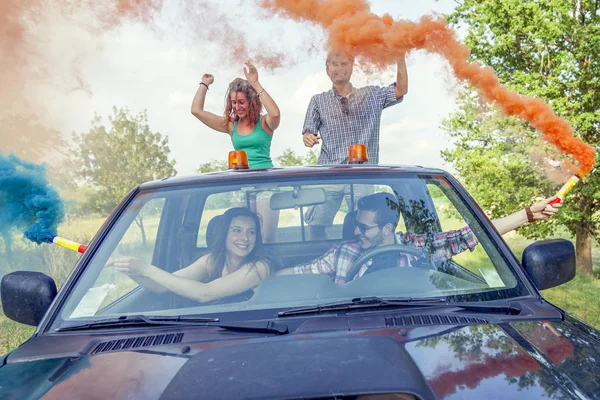 Group of young guys have fun with colored smoke trails