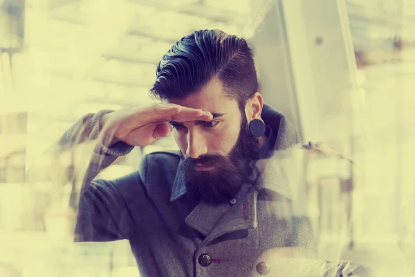 Businessman looking through window — Stock Photo, Image