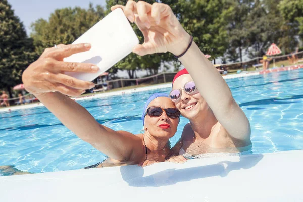 Modern mom and young daughter takes a selfie