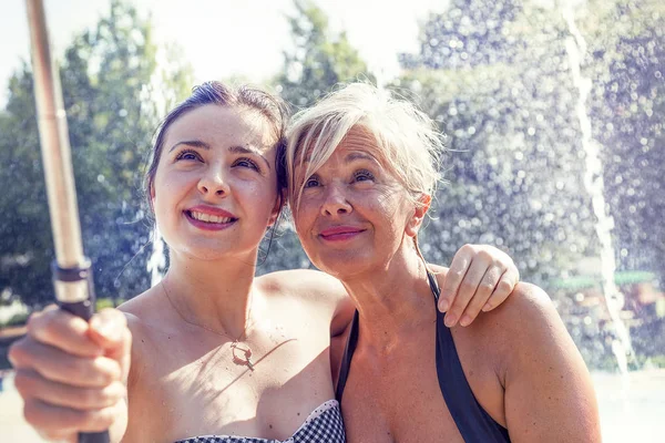 Modern mom and young daughter takes a selfie