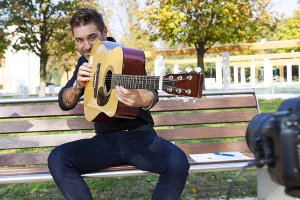 Молодий чоловік вчитель гітари робить відео — стокове фото