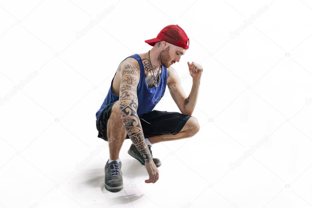 sitting tattooed rap singer posing in studio