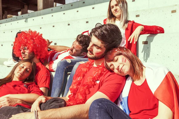 Young group of supporter fans relaxing lying down — Stock Photo, Image