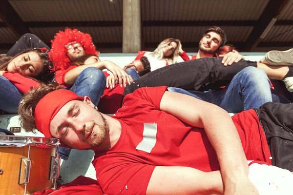 Young group of supporter fans relaxing lying down — Stock Photo, Image