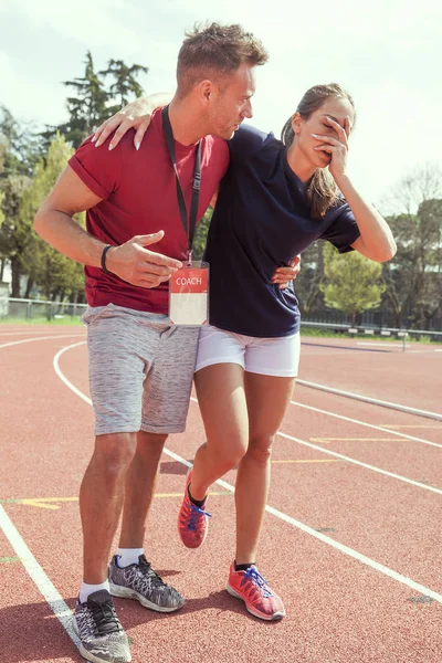 young athlete injured to knee on the track