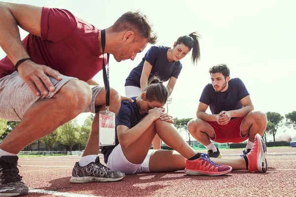 Giovane atleta infortunato al ginocchio in pista — Foto Stock