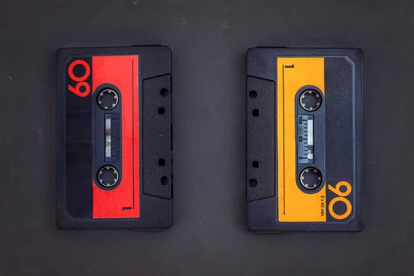 Pair of vintage audio cassettes over a black chalkboard — Stock Photo, Image