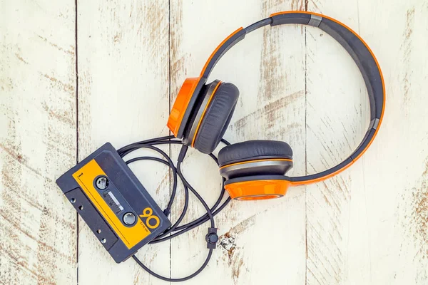 vintage audio cassettes and headphones over a black chalkboard