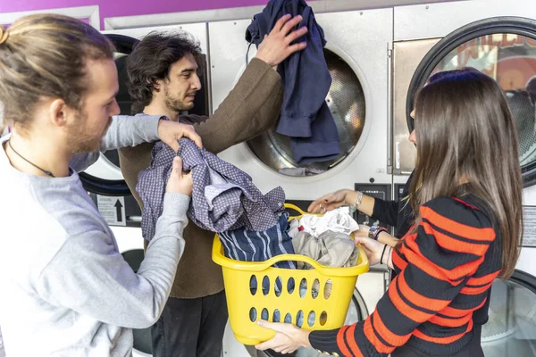 Νεανική ομάδα φίλων της χιλιετίας βάζει ρούχα στο πλυντήριο — Φωτογραφία Αρχείου