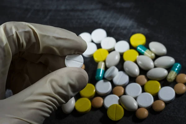 Bir el bir hap bir sürü ilaç üzerinde tutar.