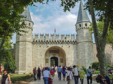 Tourists leaving the gate of salutation at the Topkapi Palace clipart