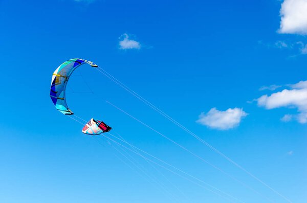 Cumbuco, Brazil, jul 9, 2017: Couple of kitesurfing  close up high by the bright blue sky background