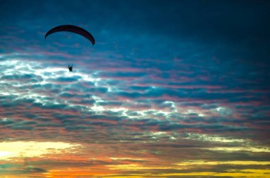Motorlu yamaçparaşütü yukarıda gökyüzü üzerinde uçan