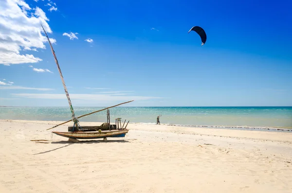 Moored jangada boat over the white sandy beach in Brazil