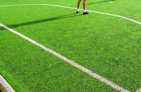 Child play on the artificial turf of the school — Stock Photo, Image