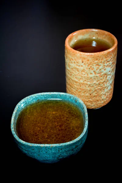 Tea in ceramic cup on black background — Stock Photo, Image