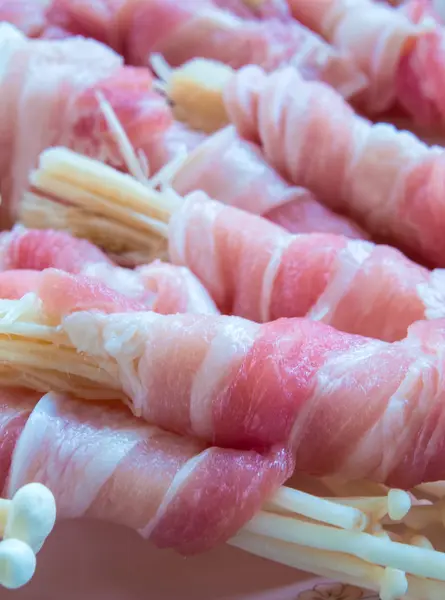 Needle Mushroom in the roll of thin sliced pork prepare to cook Royalty Free Stock Photos