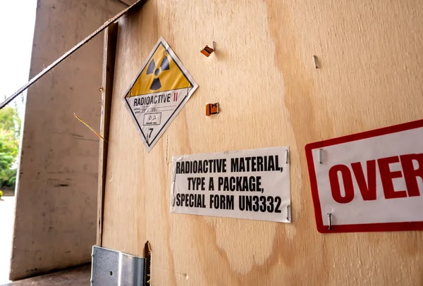 Radioactive material label beside the transportation wooden box Type A standard package in the truck