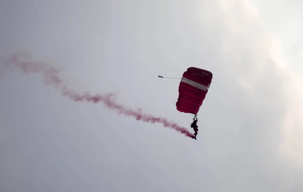 Silhueta paraquedas acrobacia desfocado e embaçado enquanto deslizando em — Fotografia de Stock