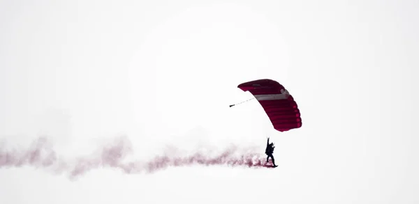 Silhouette parachute stunt unfocused and blurry while gliding in — Stock Photo, Image