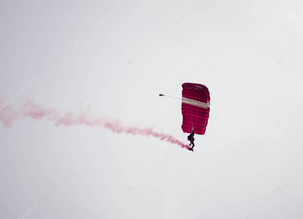 silhouette parachute stunt unfocused and blurry while gliding in